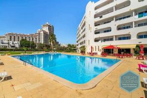 a large swimming pool in front of a building at Casa Azul 714 Dream Lodging in Albufeira