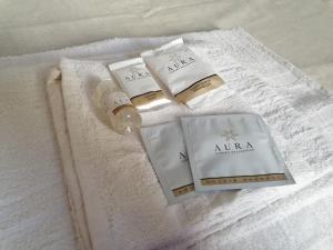 a pile of towels with a bottle of soap at Due finestre sul cortile in Novi Ligure