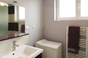 a bathroom with a sink and a toilet and a mirror at Holiday Home in Bréhal near Sandy Beach in Bréhal +15 photos