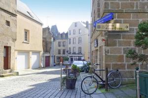 a bike parked on the side of a street at Holiday Home in Bréhal near Sandy Beach in Bréhal
