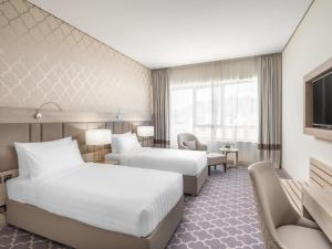Postel nebo postele na pokoji v ubytování Wirgan Hotel Al Azizyah