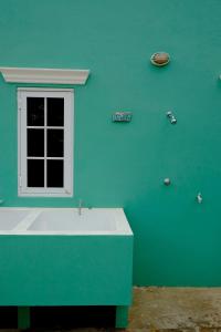 a bathroom with a blue wall with a sink at Villa Olivia Poolside in Kralendijk