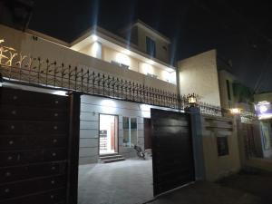 a night view of a building with a gate at Hotel Taj Palace Multan in Multan