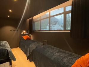 a bedroom with two beds and a window at Olden apartments 2 in Stryn