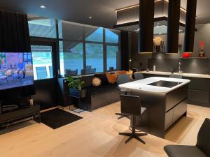 a kitchen with a living room with a couch at Olden apartments 2 in Stryn