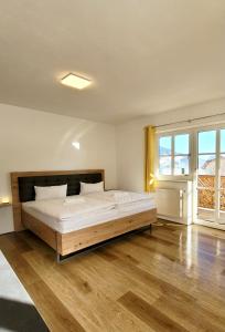 a bedroom with a large bed and a large window at Ferienwohnung Flachau Oberlehengut in Flachau