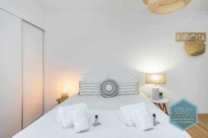 um quarto com uma cama branca e almofadas brancas em Vila Magna 603 Dream Lodging em Albufeira