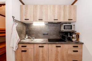 a kitchen with a sink and a microwave at Family Apt With Superb View On The Mont Blanc in Les Houches