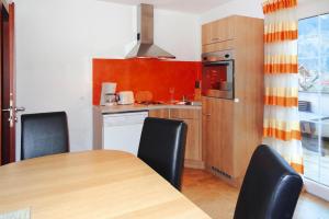a kitchen with a table and chairs in a room at Holiday flat Aschau in Aschau