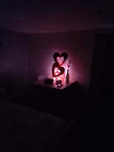 a dark room with a heart shaped light in a dark room at A La Reid Paisible in Theux