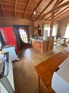 a kitchen with a refrigerator and a counter in a room at Casa Tapera Nova in Conceição da Ibitipoca