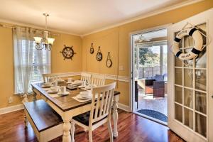 a dining room with a table and chairs at Lakefront Macon Home with Pool, Dock and Fire Pit! in Macon