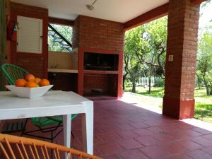 a kitchen with a table with a bowl of oranges on it at Dorado del Sol in Merlo