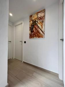 an empty hallway with a painting on the wall at Apartamentos El Bergantin Menorca Club in Fornells