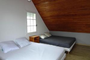 a bedroom with two beds and a window at Holiday Home in Damgan near Sandy Beaches in Damgan