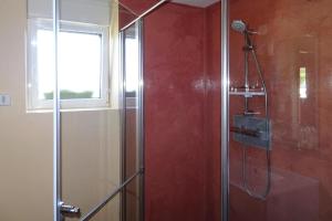 a shower with a glass door and a window at Holiday Home in Guerlesquin near Lake in Guerlesquin +18 photos
