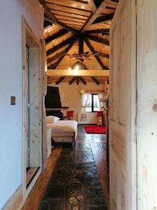 a bedroom with a bed in a room with wooden ceilings at Căsuța Con in Fundata