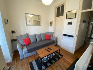 ein Wohnzimmer mit einem Sofa und einem Tisch in der Unterkunft Manjericos House in Lissabon