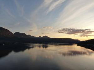 a view of a river with mountains in the background at Arctic Inn in Gratangen