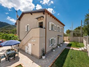 a house with a patio and a yard at Villa Chiara Solanas in Solanas