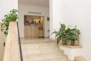 a lobby of a hospital with stairs and plants at BIVIO hotel in Bratislava