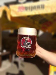 a persons hand holding a glass of beer at Lesní Restaurace Harrachovka in Tábor