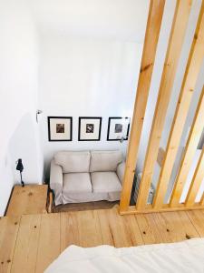 a living room with a white couch in a room at Estudio do Loureiro in Vidigueira