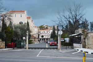 a gate to a parking lot with a car parked at Mia's Cove in Paphos
