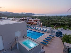 une villa avec une piscine et des chaises dans l'établissement Istron MiraBella Villas, à Istron