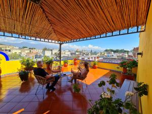 un uomo e una donna seduti su un balcone di Hotel Suites Del Centro a Città di Oaxaca