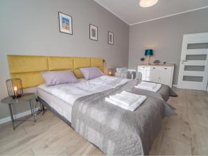 Posteľ alebo postele v izbe v ubytovaní Krosna Street Apartament