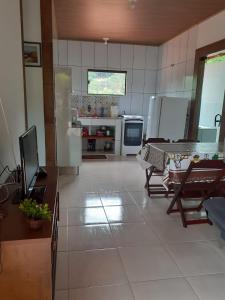 una cocina con electrodomésticos blancos y una mesa. en Casa Lumiar en Lumiar