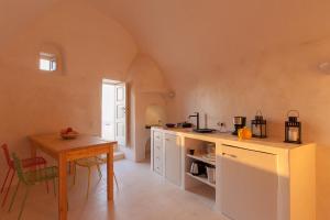 a kitchen with a table and a counter top at Castelli Torre in Emporio Santorini