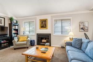 a living room with a blue couch and a coffee table at Oceanwoods 452 in Kiawah Island