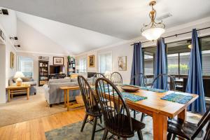a dining room and living room with a table and chairs at Oceanwoods 452 in Kiawah Island