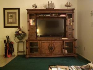 a large entertainment center with a television in a living room at Pool home by AcoralBay 5 Min to the beach in Venice