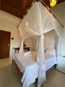 Cama ou camas em um quarto em Pousada Bahia-Nova Caraíva