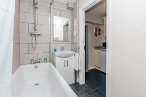 a bathroom with a tub and a sink at Honeysuckle terrace in Henley on Thames