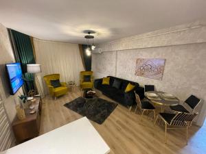 a living room with a couch and a table and chairs at King Suite SS4 in Istanbul