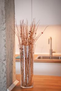 a glass vase with sticks in it on a table at Niños Luchando in Granada