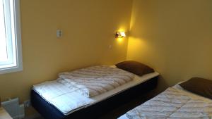 En eller flere senger på et rom på Ekesberget Stugby stuga 3