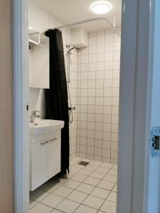 a bathroom with a shower and a sink at 300meter walk to LEGO house - 70m2 apartment with garden in Billund