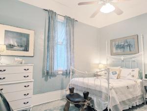 a bedroom with a bed and a ceiling fan at Royal Sunshine in New Orleans