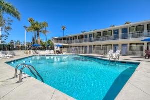 a swimming pool in front of a building at Motel 6-San Diego, CA - Hotel Circle - Mission Valley in San Diego