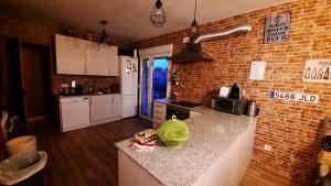 a kitchen with a dog sitting on a counter at Chalet con piscina y BBQ para 10 personas in San Martín de Valdeiglesias