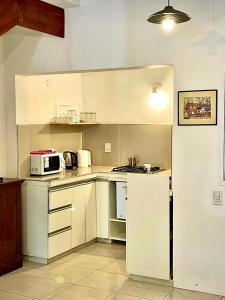 a kitchen with white cabinets and a white refrigerator at Tierras del Malbec 2 in Ciudad Lujan de Cuyo