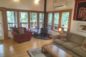 a living room with a couch and a wood stove at Moon Dance Cabin in Madeira Park