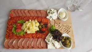 a tray of hot dogs and other food on a table at Hotel Srem in Sremska Mitrovica