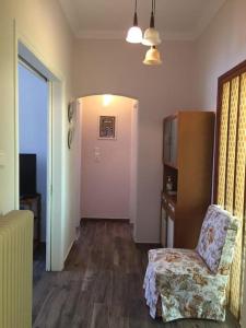 a living room with a chair and a television at Diktynna villa in Palekastron
