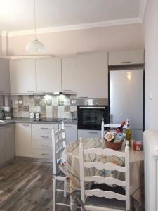 a kitchen with a table and chairs in a room at Diktynna villa in Palekastron